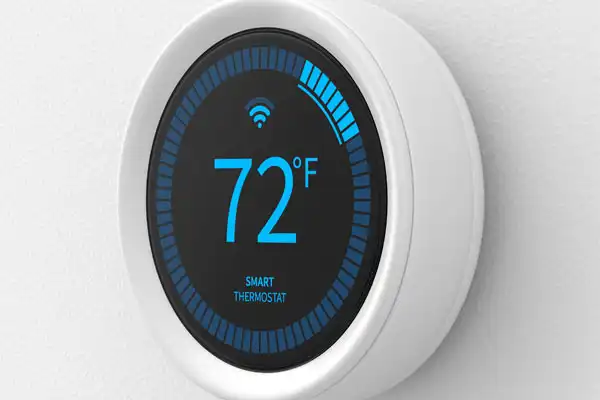 A smart thermostat displays 72 degrees Fahrenheit on a circular screen with Wi-Fi symbol.